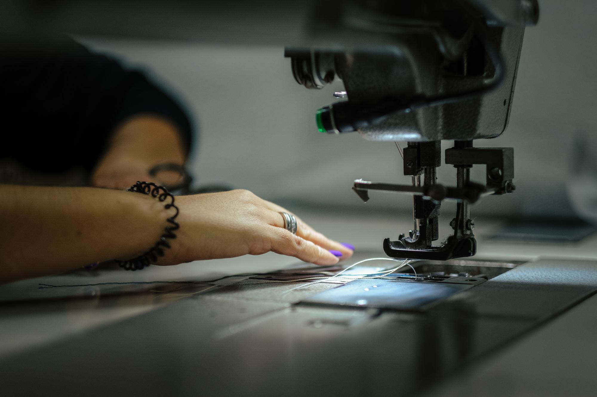 embroidered garment being inspected under LED light